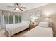Comfortable bedroom with two twin beds, ceiling fan, and large windows offering natural light at 4856 Green Dolphin Way # Share 7, Kiawah Island, SC 29455