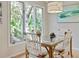 Bright dining area with a square table and large windows offering scenic outdoor views at 4856 Green Dolphin Way # Share 7, Kiawah Island, SC 29455