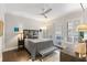 Comfortable bedroom with plush gray bedding, a ceiling fan, and access to a private outdoor space at 498 Albemarle Rd # 207, Charleston, SC 29407