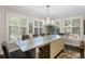 Bright dining area with chandelier, island, and large windows at 498 Albemarle Rd # 207, Charleston, SC 29407