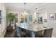 Well-lit dining room with a long island and large windows with plantation shutters at 498 Albemarle Rd # 207, Charleston, SC 29407