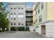 Multi-story condo building showing the garage and balconies at 498 Albemarle Rd # 207, Charleston, SC 29407