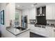 Modern gourmet kitchen with white cabinetry, granite countertops, and stainless steel appliances at 498 Albemarle Rd # 207, Charleston, SC 29407