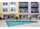 Community pool surrounded by seating and landscaping, ideal for relaxation and socializing at 498 Albemarle Rd # 207, Charleston, SC 29407