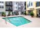 Community pool surrounded by seating and landscaping, ideal for relaxation and socializing at 498 Albemarle Rd # 207, Charleston, SC 29407