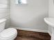 Cozy powder room featuring wood-like tile and a pedestal sink with a small window at 529 Delafield Dr # 529, Summerville, SC 29483