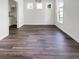 Shows hardwood floors, an entryway to a kitchen, and natural light in this empty living room at 529 Delafield Dr # 529, Summerville, SC 29483