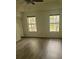 Bright bedroom with new flooring, ceiling fan, and two large windows for ample light at 638 Leisure Ln, Mount Pleasant, SC 29464