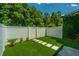 Lush backyard featuring artificial turf, stepping stones, garden plants, and tall trees at 754 Certificate Ct, Charleston, SC 29414