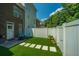 Backyard with artificial turf, stepping stones, privacy fence, and outdoor seating at 754 Certificate Ct, Charleston, SC 29414