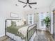 Cozy bedroom featuring a metal bed frame, ceiling fan, and windows providing natural light at 754 Certificate Ct, Charleston, SC 29414