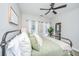 Cozy bedroom featuring a metal bed frame, ceiling fan, and windows providing natural light at 754 Certificate Ct, Charleston, SC 29414