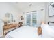 Sunlit bedroom with a bed, stylish vanity, woven decor, and view of the outdoors at 754 Certificate Ct, Charleston, SC 29414