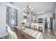Charming dining area featuring a chandelier, wood table, and open access to the kitchen with stainless steel appliances at 754 Certificate Ct, Charleston, SC 29414