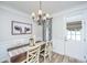 Charming dining area featuring a chandelier, wood table, and decorative artwork at 754 Certificate Ct, Charleston, SC 29414