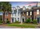 Beautiful townhome exterior featuring brick, white siding, and a well-manicured lawn at 754 Certificate Ct, Charleston, SC 29414