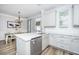 Bright kitchen with white cabinets, a stainless steel dishwasher, and a dining area at 754 Certificate Ct, Charleston, SC 29414