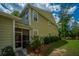 Back exterior of home with screened porch entrance and greenery at 78 Branch Creek Trl, Summerville, SC 29483
