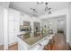 Bright, modern kitchen featuring a large granite island, stainless steel appliances, and white cabinets at 78 Branch Creek Trl, Summerville, SC 29483