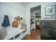 Welcoming mudroom features shiplap walls, a built-in bench, and decorative hooks at 78 Branch Creek Trl, Summerville, SC 29483