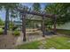 Community playground with pergola-covered picnic area, seating, and outdoor grill for Gathering gatherings and fun at 78 Branch Creek Trl, Summerville, SC 29483