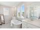 Elegant bathroom featuring a soaking tub, double vanity, and bright natural light at 782 Clay Field Trl, Summerville, SC 29485