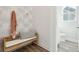 Inviting entryway with stylish bench, decorative wallpaper, and convenient access to a powder room at 782 Clay Field Trl, Summerville, SC 29485