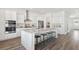 Open-concept kitchen with an island, stainless steel appliances, and sleek white cabinetry at 782 Clay Field Trl, Summerville, SC 29485