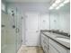 Modern bathroom featuring double sinks, gray quartz countertops, white cabinets, and a glass-enclosed shower at 8035 Mckayla Rd, Summerville, SC 29483