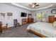 Large bedroom featuring gray carpet, a ceiling fan, wood furniture and two large windows for natural light at 8035 Mckayla Rd, Summerville, SC 29483