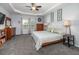 This spacious bedroom features a tray ceiling, carpet floors, and lots of natural light from the windows at 8035 Mckayla Rd, Summerville, SC 29483
