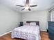 Bedroom features hard wood floors, ceiling fan, neutral decor, and a comfortable bed for relaxation at 8035 Mckayla Rd, Summerville, SC 29483