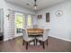 Cozy dining room featuring a round wooden table, upholstered chairs, and natural lighting at 8035 Mckayla Rd, Summerville, SC 29483