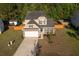 Two-story home boasting a manicured lawn, inviting curb appeal, and an attached garage on a sunny day at 8035 Mckayla Rd, Summerville, SC 29483