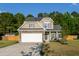 Beautiful two-story home featuring stone accents, a manicured lawn, and a convenient two-car garage at 8035 Mckayla Rd, Summerville, SC 29483