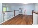 Bright open hallway featuring hardwood floors and natural light from the window at 8035 Mckayla Rd, Summerville, SC 29483