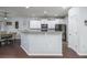 View of kitchen with white cabinets, gray countertops, stainless steel appliances, and hardwood floors at 8035 Mckayla Rd, Summerville, SC 29483