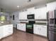 Bright kitchen with stainless steel appliances, white cabinets, and grey countertops at 8035 Mckayla Rd, Summerville, SC 29483