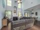 Bright living room features a fireplace, high ceilings, wood floors, and a comfortable leather sofa at 8035 Mckayla Rd, Summerville, SC 29483