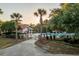 Community pool area with palm trees, lounge chairs, and well-maintained landscaping for relaxation and enjoyment at 8035 Mckayla Rd, Summerville, SC 29483