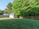 Backyard shed with fenced yard and mature trees at 8035 Mckayla Rd, Summerville, SC 29483