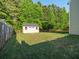 A backyard shed with adjacent lawn, fencing and mature trees at 8035 Mckayla Rd, Summerville, SC 29483