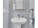 Traditional-style bathroom with gray walls, a pedestal sink, and a silver framed mirror at 822 Rue Dr, Charleston, SC 29414