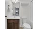This bathroom has a toilet, sink, mirror, and neutral color scheme at 822 Rue Dr, Charleston, SC 29414