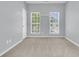 This bedroom has two windows and a light blue paint color at 822 Rue Dr, Charleston, SC 29414