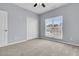 This bedroom has neutral carpet, light blue walls, and a large window at 822 Rue Dr, Charleston, SC 29414