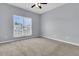 This bedroom has neutral carpet, light blue walls, and a ceiling fan at 822 Rue Dr, Charleston, SC 29414