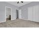 This bedroom features neutral carpet and a connecting bathroom at 822 Rue Dr, Charleston, SC 29414