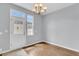 Charming dining area with a chandelier, natural light, and adjacent entry door at 822 Rue Dr, Charleston, SC 29414