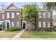 Charming brick townhome featuring a well-manicured lawn and welcoming front entrance at 822 Rue Dr, Charleston, SC 29414